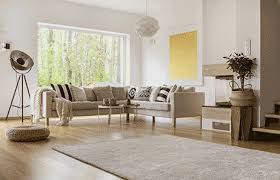 Modern living room designed with Vastu Shastra principles, featuring neutral tones and natural elements.