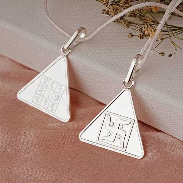 Triangular Pyra Yantra pendants for positive energy and well-being.