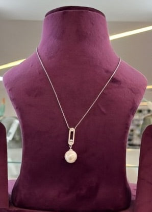 Aylin Pearl Silver Pendant on display stand, featuring a pearl design for astrology enthusiasts.