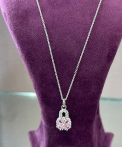 Luna Rosé Silver Pendant with pink astrology stone on purple display.
