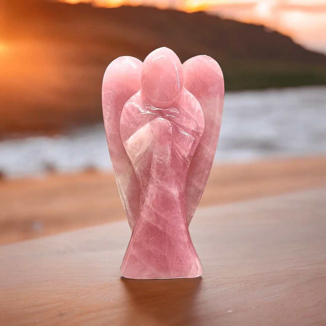 Angel Rose Quartz crystal shaped as an angel, promoting love and healing energy.