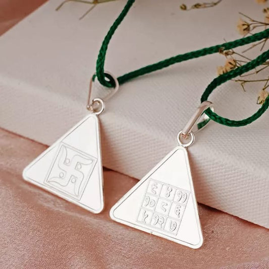 Budh Yantra pendants with Vedic symbols on green cords for enhancing communication and intellect.