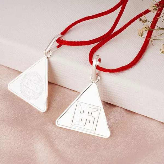 Silver Surya Yantra pendant with red thread, symbolizing vitality and positive energy.