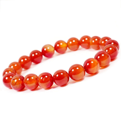 Carnelian bracelet with vibrant orange beads, known for boosting creativity and confidence.
