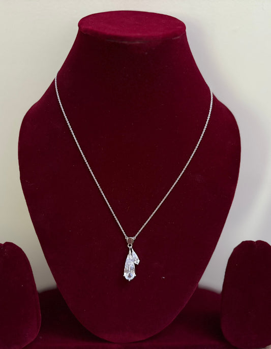 The Rosavelle Drop Silver Pendant on a velvet display stand.