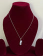 The Rosavelle Drop Silver Pendant on a velvet display stand.