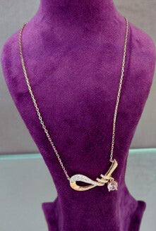 Roselle D’Or Silver Pendant on purple display.