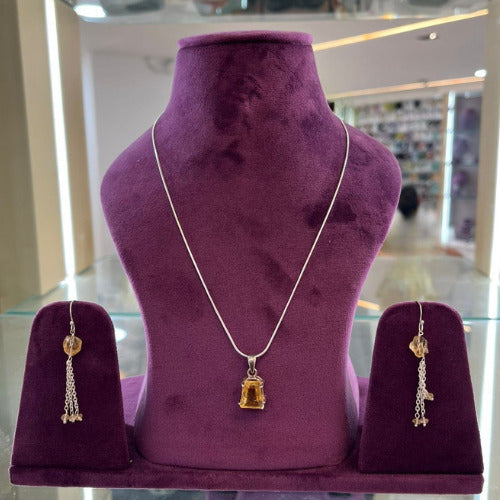 Aurya Lux Silver Set displayed on a purple stand with necklace and earrings.