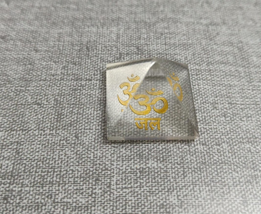 Om Jal Pyramid with gold Om symbol, enhances energy for meditation and manifestation.