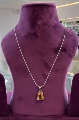 Aurya Lux Silver Pendant displayed on a purple velvet stand.